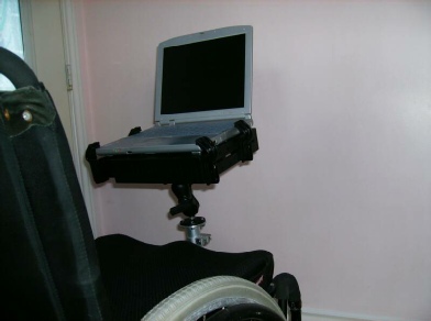 Photo of a wheelchair with the Mobility Mount and Laptop bracket attached to the wheelchair